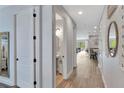 Bright hallway with wood floors leading to an open-concept living area at 7519 Marker Ave, Kissimmee, FL 34747