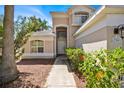 Inviting front entrance with a decorative door and manicured landscaping at 786 Oxford Dr, Davenport, FL 33897