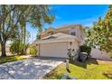 Charming two-story home with a well-maintained lawn and a spacious two-car garage at 786 Oxford Dr, Davenport, FL 33897