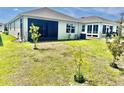 Spacious backyard featuring young trees, offering potential for landscaping and outdoor enjoyment at 7871 Penrose Pl, Wildwood, FL 34785