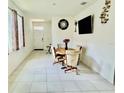 Cozy dining area with natural light, tile floors, and an inviting atmosphere at 7871 Penrose Pl, Wildwood, FL 34785