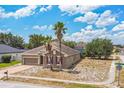 Single-story home on corner lot with palm trees, brick driveway, and well-maintained lawn at 807 Ayden Oak Ln, Ocoee, FL 34761