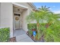 Inviting front entryway featuring decorative plants and a wreath adorning the front door at 822 Sheen Cir, Haines City, FL 33844