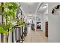 Bright hallway with tiled floors, arched doorways, and decorative elements leading to other rooms at 822 Sheen Cir, Haines City, FL 33844