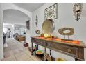 Inviting entryway with stylish console table, decorative art, and an archway into the living room at 822 Sheen Cir, Haines City, FL 33844