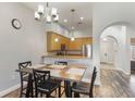 Cozy dining area adjacent to the kitchen, featuring modern lighting and wood-look flooring at 9055 Treasure Trove Ln # 501, Kissimmee, FL 34747