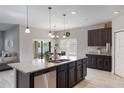 Bright, modern kitchen featuring a large island, stainless steel appliances, and seamless flow to the dining area at 112 Red Maple Burl Cir, Debary, FL 32713