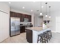 Modern kitchen with granite countertops, stainless steel appliances, and a large island with seating at 112 Red Maple Burl Cir, Debary, FL 32713