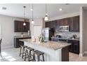Modern kitchen with granite countertops, stainless steel appliances, and a large island with seating at 112 Red Maple Burl Cir, Debary, FL 32713