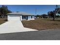Single story home featuring a 2-car garage, light blue exterior and a concrete driveway at 14145 Sw 47Th Ave, Ocala, FL 34481