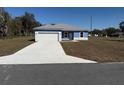 Single story home featuring a 2-car garage, light blue exterior and a concrete driveway at 14145 Sw 47Th Ave, Ocala, FL 34481