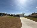 Wide view of a modern home with a long driveway and green lawn in a suburban setting at 15164 Sw 46Th Cir, Ocala, FL 34473