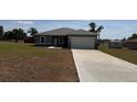 New single-story home boasts a manicured front lawn and a freshly paved driveway at 15164 Sw 46Th Cir, Ocala, FL 34473