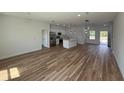 Open-concept living space with wood-look flooring, recessed lighting, and seamless flow into kitchen at 15164 Sw 46Th Cir, Ocala, FL 34473