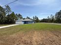 Attractive home with blue exterior, spacious front lawn, and ample space for outdoor activities at 15259 Sw 51St Cir, Ocala, FL 34473