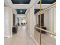 Modern foyer featuring tiled floors, high ceilings, stylish mirror, and decorative accents at 15335 Rising View Dr, Montverde, FL 34756