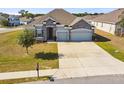 Attractive one-story home boasting stone accents, a two-car garage, and a generous driveway at 1816 Forest Glen Dr, Fruitland Park, FL 34731