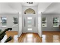 Bright foyer with hardwood floors, a modern front door, and large windows at 1901 Lakeshore Cir, Longwood, FL 32750
