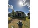 Home exterior, with a view of a young tree planted in the lawn at 2082 Gold Dust Dr, Clermont, FL 34715