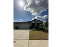 Charming single-story home featuring a two-car garage and stone pillar accents at 2082 Gold Dust Dr, Clermont, FL 34715