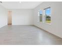Bright living room featuring modern tile floors and two windows offering ample natural light at 2170 Derwent Dr, Davenport, FL 33896