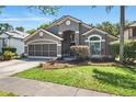 Beautiful gray single-story home featuring mature landscaping and a well-maintained lawn at 2611 Burwood Ave, Orlando, FL 32837