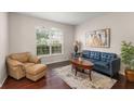 Cozy living room featuring hardwood floors, a leather sofa, and natural light at 2644 Slagrove Ct, Winter Garden, FL 34787