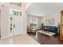 Bright living room featuring tile entry, hardwood floors, and a large window at 2644 Slagrove Ct, Winter Garden, FL 34787
