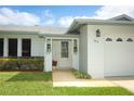 Close-up of the home's facade, highlighting the front door, landscaping, and attached garage at 3317 Dormer Ct, Winter Park, FL 32792