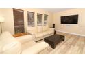 Comfortable living room with modern furniture, wood-look floors, and ample natural light at 3317 Dormer Ct, Winter Park, FL 32792