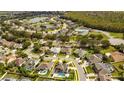 Aerial view of a beautiful home with a pool in a suburban neighborhood near a lake and natural preserve at 3532 Amaca Cir, Orlando, FL 32837