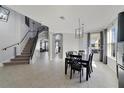 Spacious dining room with staircase and modern lighting at 3680 Ricky Ln, St Cloud, FL 34772