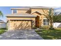 Inviting home with a two-car garage, warm colors, and stone veneer accents at 3680 Ricky Ln, St Cloud, FL 34772
