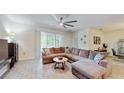Spacious living room with tile flooring, modern lighting, and a comfortable sectional sofa at 4191 Holstein St, St Cloud, FL 34772