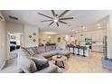 Open-concept living and dining area with a kitchen island and modern bar stools at 4191 Holstein St, St Cloud, FL 34772