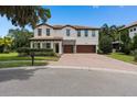 Charming two-story home boasts a tile roof, stone accents, and a well-maintained lawn at 4509 Patricia Ann Ct, Orlando, FL 32839