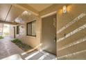 The condo entrance features unit number, neutral paint, and is illuminated by overhead lighting at 5321 Vineland Rd # 101, Orlando, FL 32811