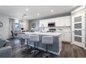 Modern kitchen featuring a central island, white cabinetry, stainless steel appliances, and pendant lighting at 555 Meadow Bend Dr, Davenport, FL 33837