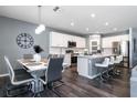 Open concept kitchen with white cabinets, stainless steel appliances, an island, and eat-in dining space at 555 Meadow Bend Dr, Davenport, FL 33837