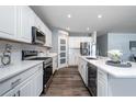Bright kitchen featuring white cabinets, stainless appliances, and a center island with a wine cooler at 555 Meadow Bend Dr, Davenport, FL 33837