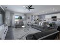 Open concept living room with comfortable seating, a ceiling fan, neutral tones, and natural light at 555 Meadow Bend Dr, Davenport, FL 33837