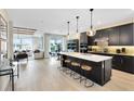 Open concept kitchen with a large island, modern appliances, and hardwood floors at 5615 Wood Bridge Pl, St Cloud, FL 34771