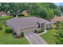 Aerial view of a well-maintained home featuring an attached garage at 609 Westview Dr, Minneola, FL 34715