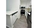 Bright kitchen featuring white cabinets, stainless steel appliances, and modern countertops at 6328 Raleigh St # 816, Orlando, FL 32835