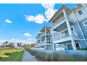 Beautiful light-blue exterior with white trim and multiple balconies near the beach at 7 Marden Dr, Ormond Beach, FL 32176