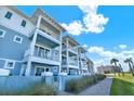 Beautiful light-blue exterior with white trim and multiple balconies near palm trees at 7 Marden Dr, Ormond Beach, FL 32176