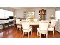 Spacious dining room with hardwood floors, six chairs, and an elegant china cabinet at 7407 Country Run Pkwy, Orlando, FL 32818