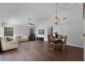 Spacious living area with hardwood floors, vaulted ceilings, and a comfortable seating arrangement at 8004 Village Green Rd, Orlando, FL 32818