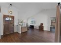 Bright living room with hardwood floors, vaulted ceilings, and a large window for natural light at 8004 Village Green Rd, Orlando, FL 32818