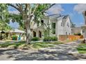 Beautiful two-story home featuring modern architecture and a well-maintained lawn, complemented by a mature tree at 833 Dartmouth St, Orlando, FL 32804